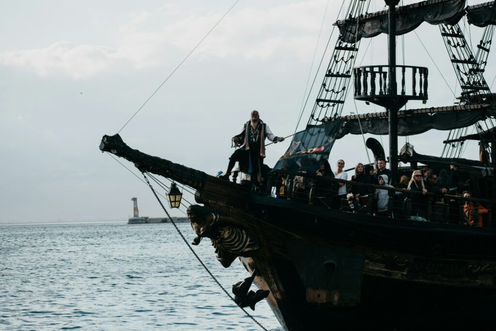 a group of people standing on top of a pirate ship