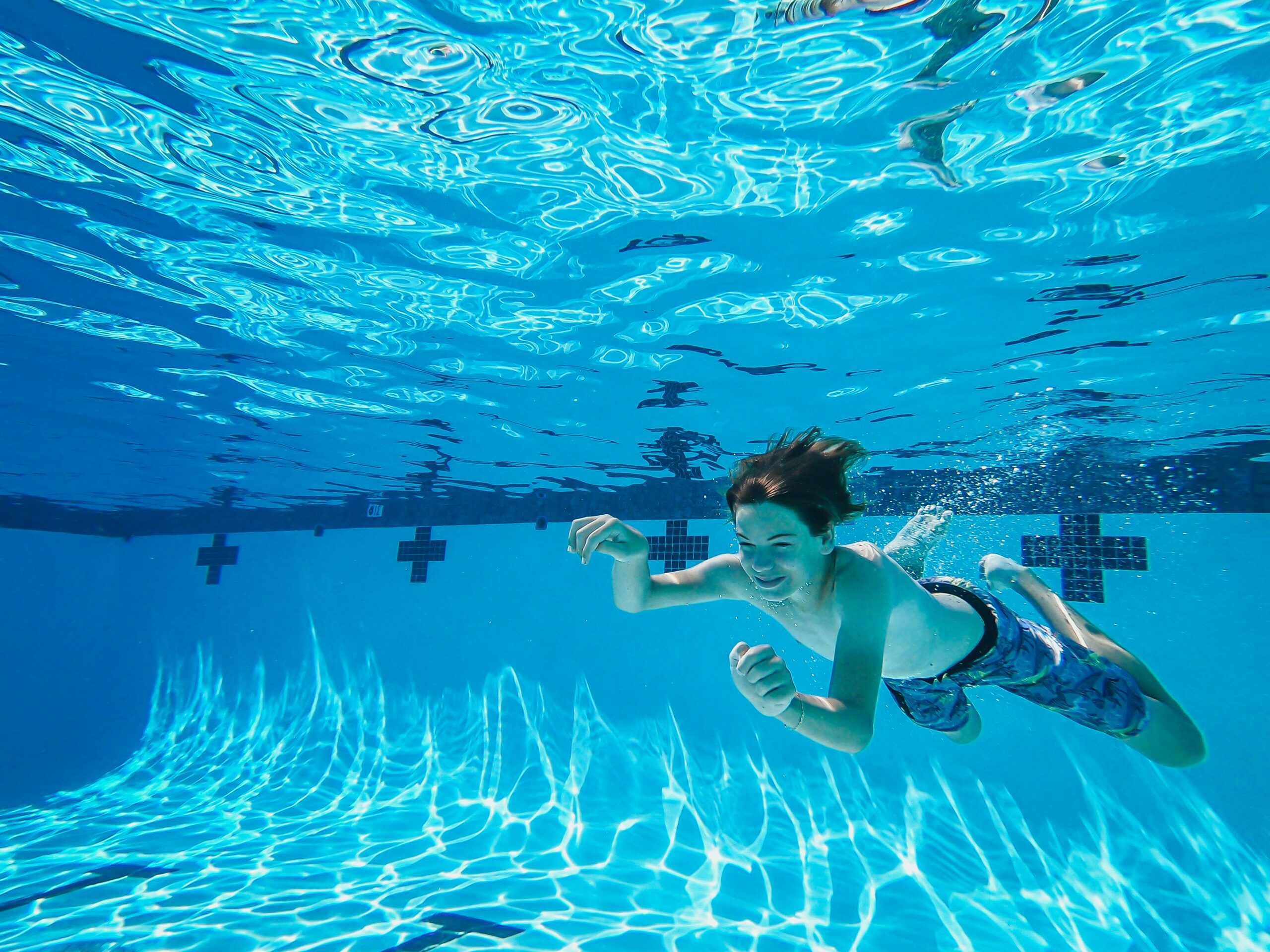 Photograph of a boy swimming underwater
