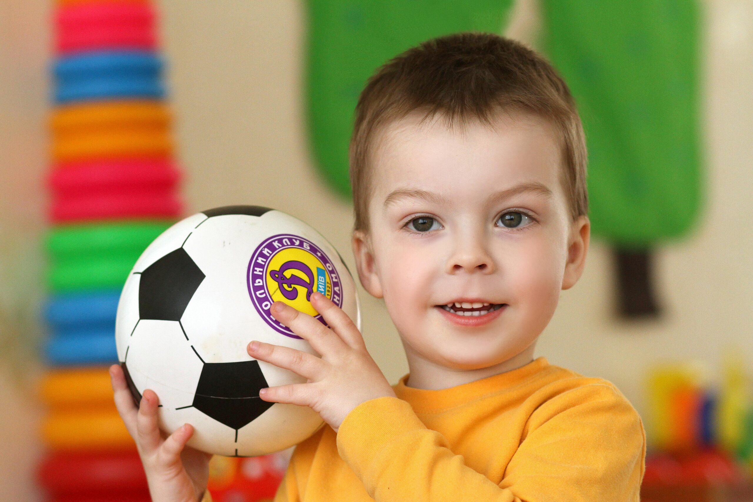 A boy holding a soccer ball